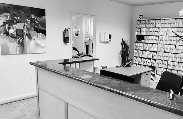 The reception desk at Bethesda Chevy Chase Advanced Dentistry, in black and white.